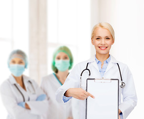 Image showing smiling female doctor with clipboard