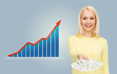 Image showing smiling woman with growth chart and dollar money