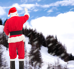 Image showing man in costume of santa claus writing something