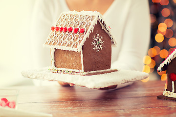 Image showing close up of woman showing gingerbread house