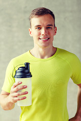 Image showing smiling man with protein shake bottle