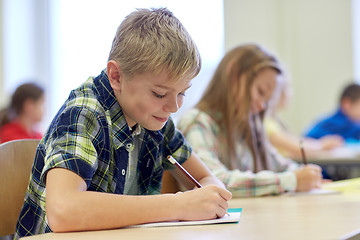 Image showing group of school kids writing test in classroom