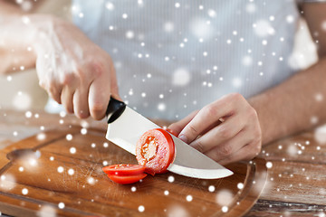 Image showing close up of man cutting vegetables with knife