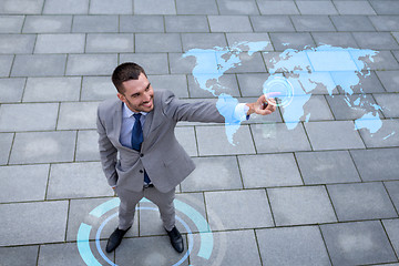 Image showing smiling businessman with world map projection