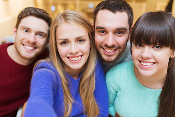 Image showing group of smiling friends taking selfie