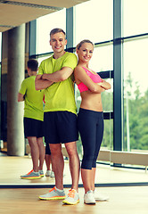 Image showing smiling man and woman in gym