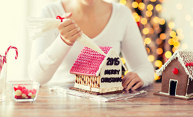 Image showing close up of woman making gingerbread houses