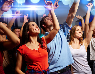 Image showing smiling friends at concert in club