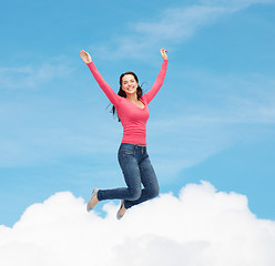 Image showing smiling young woman jumping in air