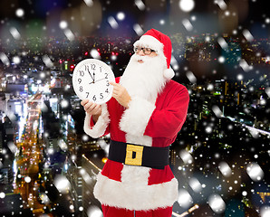 Image showing man in costume of santa claus with clock