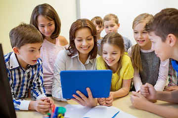 Image showing group of kids with teacher and tablet pc at school