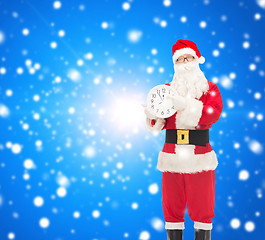 Image showing man in costume of santa claus with clock