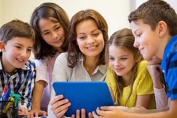 Image showing group of kids with teacher and tablet pc at school