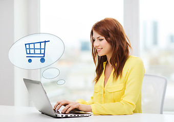 Image showing smiling woman with laptop computer shopping online