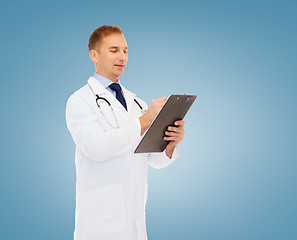 Image showing smiling male doctor with clipboard and stethoscope