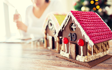 Image showing close up of woman making gingerbread houses