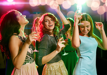 Image showing smiling friends with glasses of champagne in club