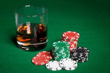 Image showing close up of casino chips and whisky glass on table