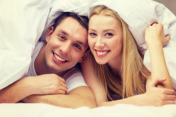 Image showing happy couple sleeping in bed