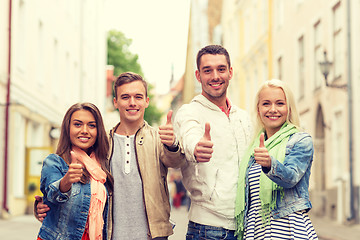 Image showing group of smiling friends showing thumbs up