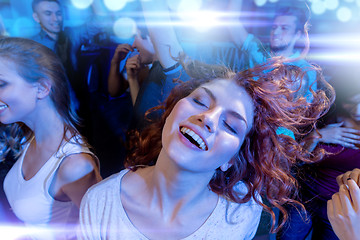 Image showing smiling friends dancing in club