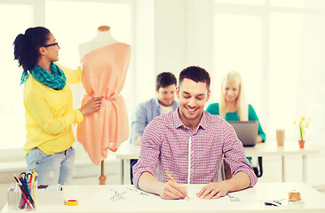 Image showing smiling fashion designers working in office