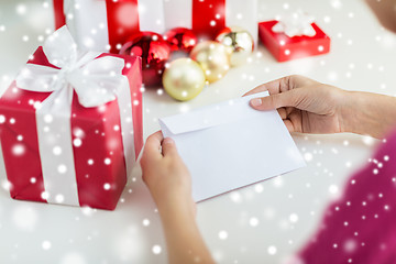 Image showing close up of woman with letter and presents