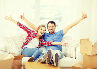 Image showing smiling couple relaxing on sofa in new home