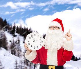 Image showing man in costume of santa claus with clock