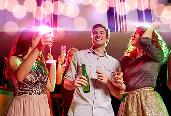 Image showing smiling friends with wine glasses and beer in club