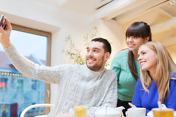 Image showing group of friends taking selfie with smartphone