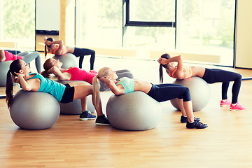 Image showing group of smiling women with exercise balls in gym