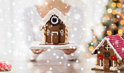 Image showing close up of woman showing gingerbread house