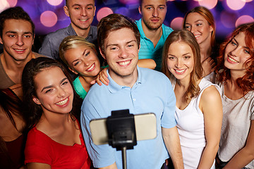 Image showing friends with smartphone taking selfie in club