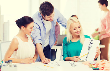 Image showing smiling fashion designers working in office