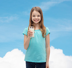 Image showing smiling little girl with glass of milk