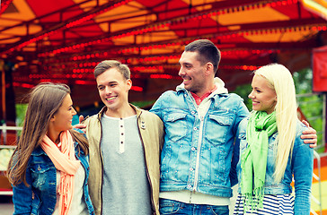 Image showing group of smiling friends in amusement park