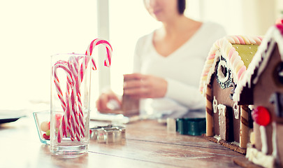 Image showing close up of woman making gingerbread houses