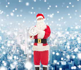 Image showing man in costume of santa claus with clock