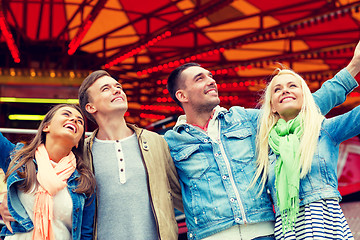 Image showing group of smiling friends in amusement park