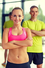 Image showing smiling man and woman in gym