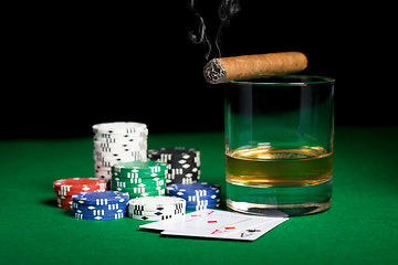 Image showing close up of chips, cards whisky and cigar on table