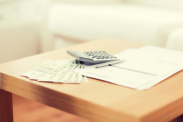 Image showing close up of money and calculator on table at home