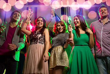 Image showing smiling friends with glasses of champagne in club