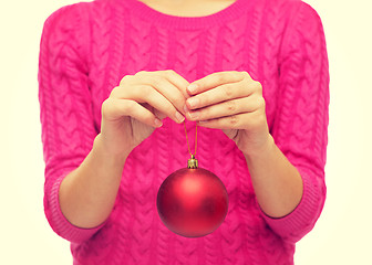 Image showing close up of woman in sweater with christmas ball