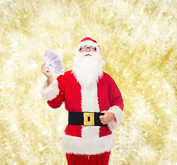 Image showing man in costume of santa claus with euro money