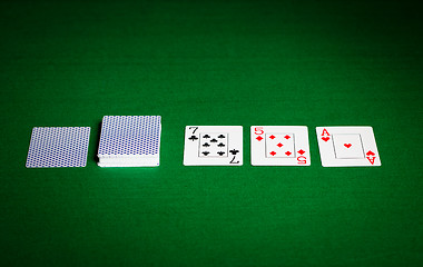 Image showing playing cards on green table surface