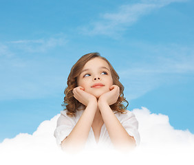 Image showing beautiful girl sitting at table and looking up