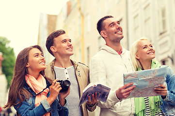 Image showing group of friends with city guide, map and camera