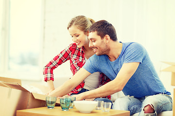 Image showing smiling couple unpacking kitchenwear